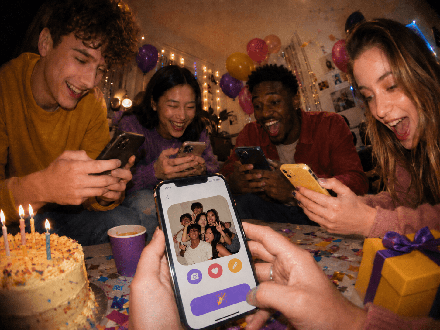 Friends using phones together at a birthday party